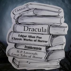 May include: A stack of black and white illustrated books with titles including "Carrie", "Metamorphosis", "Dracula", "Edgar Allan Poe: Classic Works of Horror", "Frankenstein", and "H.P. Lovecraft: Great Tales of Horror".