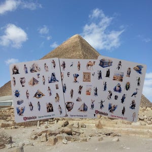 May include: Three white sticker sheets featuring various colourful illustrations of Egyptian mythology figures, artefacts, and symbols. Each sheet includes the text StickyBrains.Etsy.Com and Egyptian Mythology 2025 printed in red at the bottom.