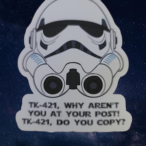 May include: A white sticker featuring a black and white illustration of a Star Wars Stormtrooper helmet. The text on the sticker reads "TK-421, WHY AREN'T YOU AT YOUR POST! TK-421, DO YOU COPY?"