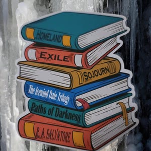May include: A sticker featuring a stack of six books with titles including "Homeland", "Exile", and "Paths of Darkness". The books have colorful covers in shades of blue, orange, and red, with gold and red accents. The author's name, R.A. Salvatore, is visible.