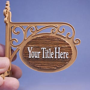 May include: A decorative sign with the text "Your Title Here" in white lettering. The sign has a brown, wood-like oval shape and is held by a decorative, ornate bracket in a gold color.