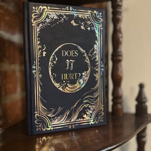 Does It Hurt? bookbind by H. D. Carlton- Custom Book Bind With Choice silver/gold, Iridescent- Special Edition Dark Blue Faux Leather Fabric