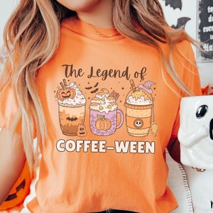 May include: Orange t-shirt with the text "The Legend of Coffee-Ween" and a graphic of three pumpkin spice coffee drinks with fall-themed decorations.