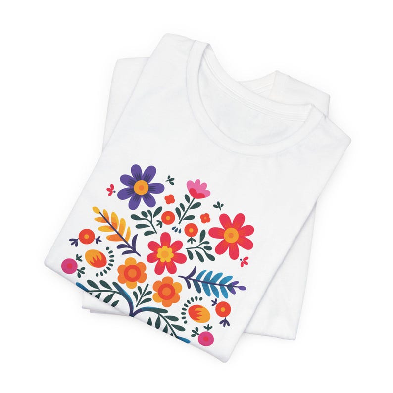Camiseta "Proteger y defender a los inmigrantes": colorida camiseta de arte popular mexicano con flores. Nadie es ilegal en tierras robadas. Los inmigrantes hacen que Estados Unidos sea grandioso. White