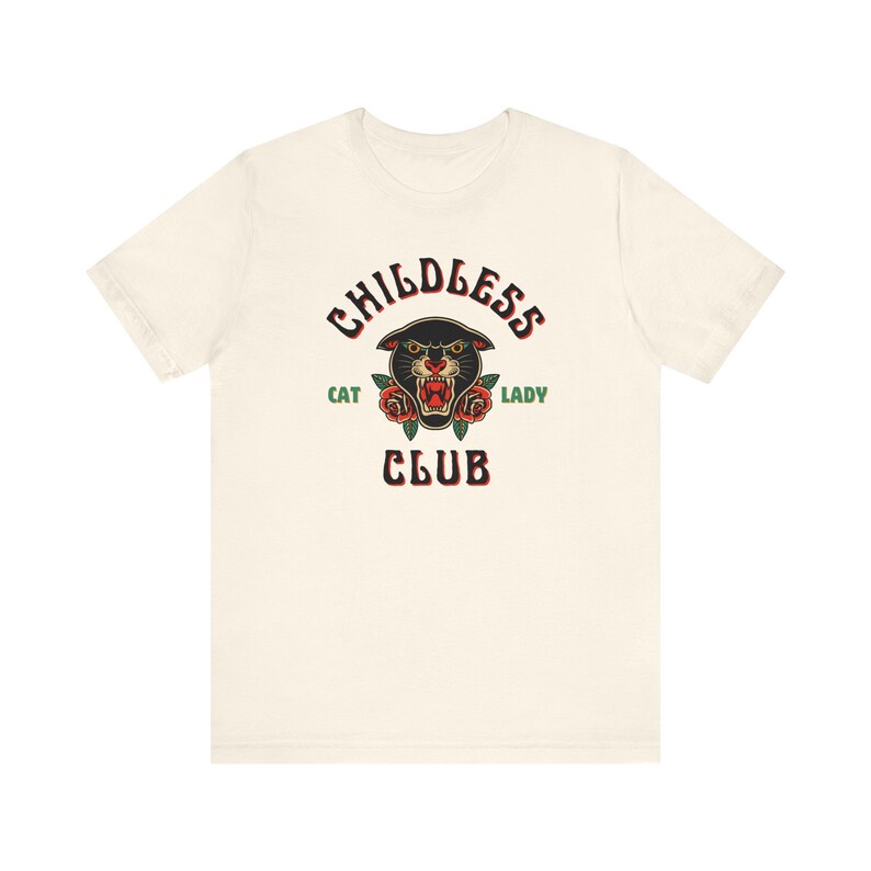 May include: A white t-shirt with a black panther head graphic and the text "Childless Cat Lady Club" in black and green.