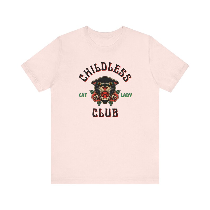 May include: A pink t-shirt with a black panther head graphic and the text "Childless Cat Lady Club" in black and green.