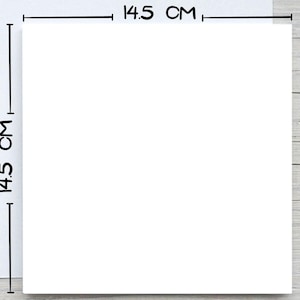 May include: A white square with dimensions of 14.5 cm (5.7 inches) on a light wood grain surface. The dimensions are indicated with black lines and text. The image is a top-down view.