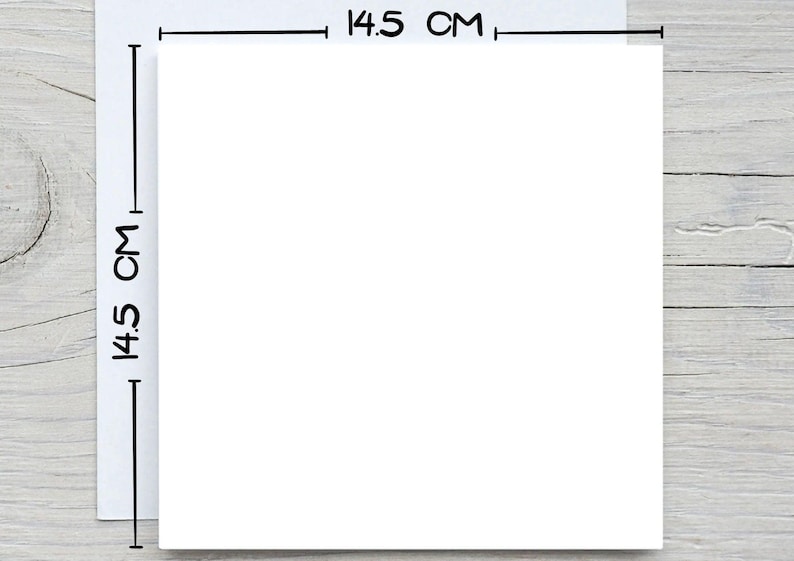 May include: A white square with dimensions of 14.5 cm (5.7 inches) on a light wood grain surface. The dimensions are indicated with black lines and text. The image is a top-down view.