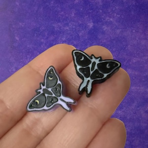 May include: A set of three ceramic mugs with a speckled, matte finish. Each mug features a different color: light blue, cream, and gray. The mugs have a simple, modern design and a comfortable handle.