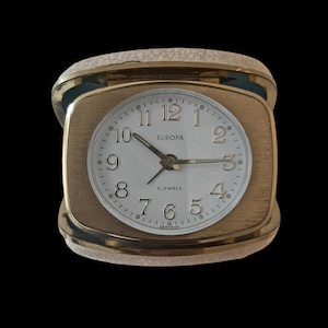 Vintage Europa Travel Alarm Clock 2 Jewels Mechanical in a leather square case.