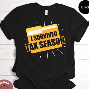 May include: Black t-shirt with a yellow folder graphic and the text "I Survived Tax Season".
