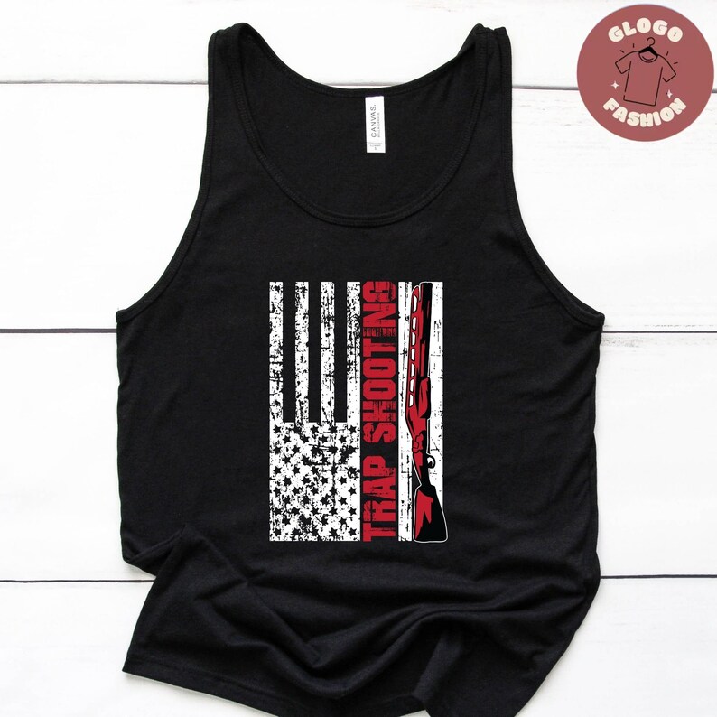 May include: Black tank top with a distressed American flag design and the text "Trap Shooting" in red.