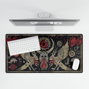 May include: Black and gold mousepad with a design of two mythical creatures with wings and a horned figure in the center. The design includes geometric shapes and symbols in red, white, and gold.