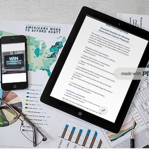May include: A tablet computer displaying a checklist titled "Essential Checklist for Winning Government Contract Proposals" with a smartphone displaying the text "WIN GOVERNMENT CONTRACTS" on a table with charts and graphs.