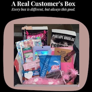 May include: A Real Customer's Box filled with various items. The box contains books, snacks, and beauty products. The text on the box reads "A Real Customer's Box" and "Every box is different, but always this good."