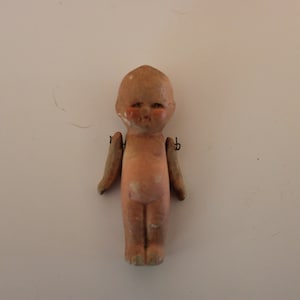 Miniature doll with articulated arms and stiff legs, 2.5" tall, Made in Japan 1930s