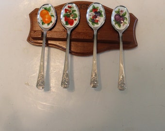 SET of FOUR collectible fruit spoons in wooden rack (oranges, raspberries, strawberries and plums)
