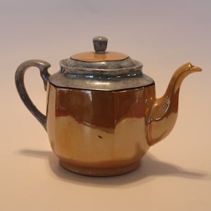 Lusterware teapot. Lusterware is a type of pottery or porcelain with a metallic glaze that gives the effect of iridescence.