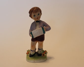 Figurine, boy with accordion and bowtie