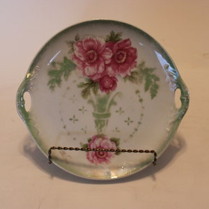Cake plate, 8.75&quot; diameter, Made in Germany and marked 285, depicting roses in a stylistic green vase