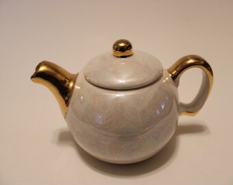 Iridescent teapot, gold trimmed spout, handle and knob