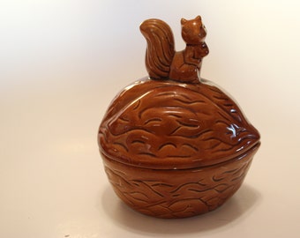 Cookie jar, squirrel on top of a walnut lid. Cute!