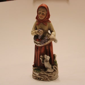 HomCo Figurine, old woman selling fruit from her apron, with a dog at her feet