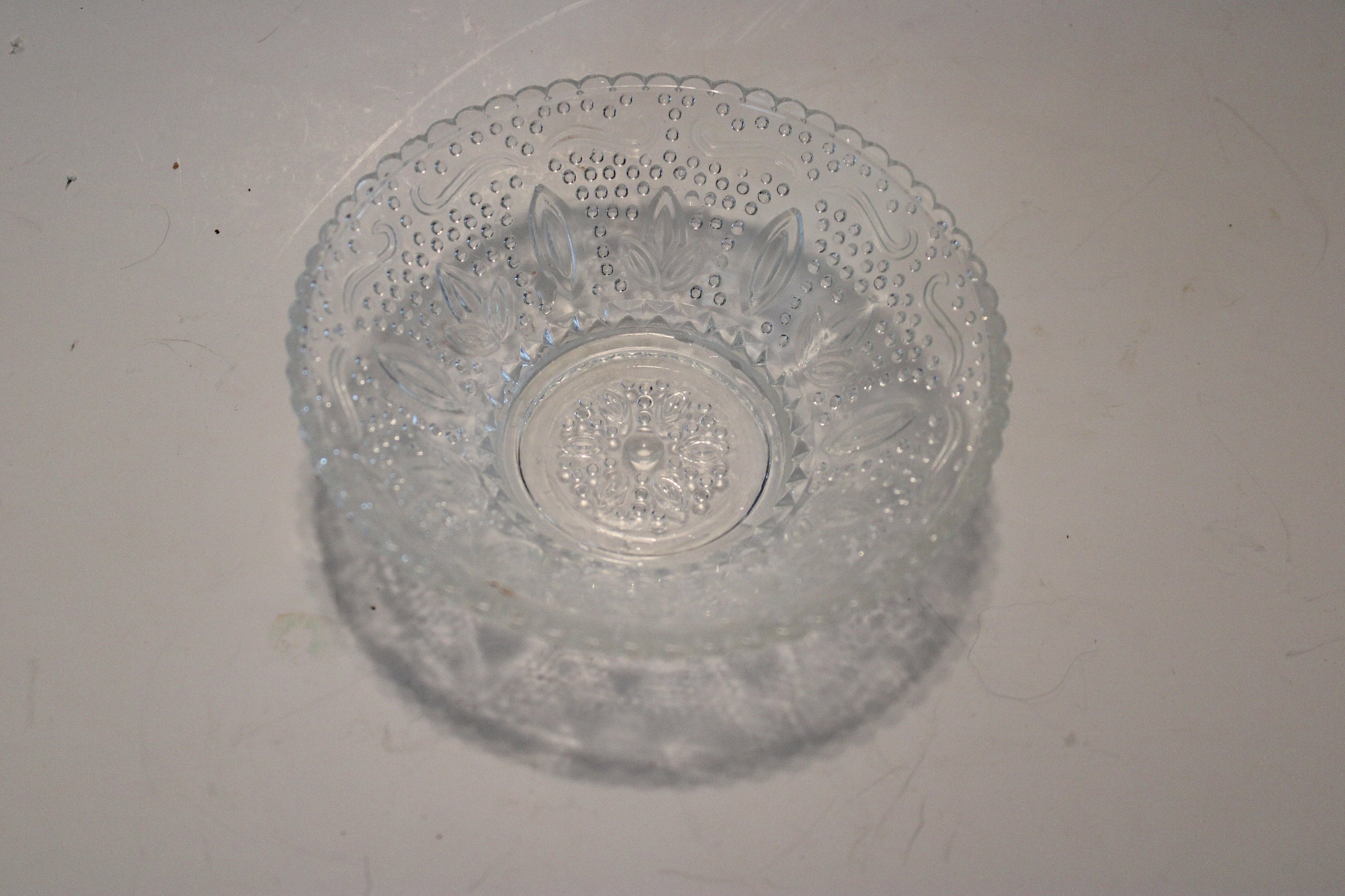 Beaded glass trinket dish, 5" in diameter, serrated edge