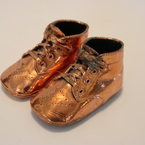 Coppered keepsake vintage baby shoes with laces and patterned uppersc