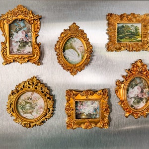 May include: Six ornate gold picture frames with various floral and nature scenes. The frames are all different sizes and shapes, but they have a similar ornate design.
