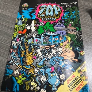 May include: A comic book cover with a colorful illustration of a cartoon character with a large head and a crown. The cover is titled "Zap Comix" and features the text "Adults Only! 75&cent;" and "Special Business Executive Issue!"