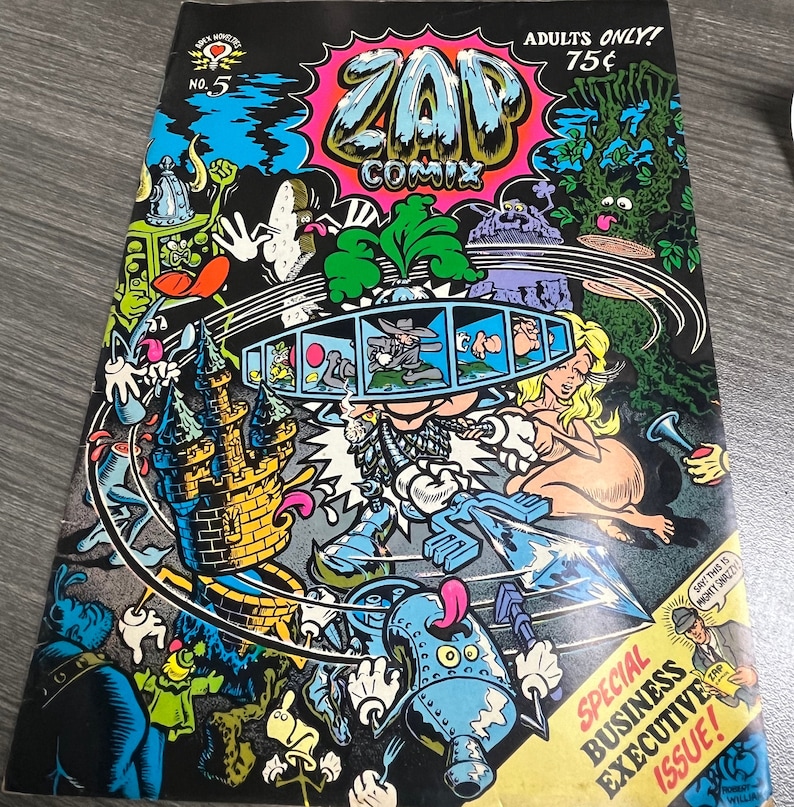 May include: A comic book cover with a colorful illustration of a cartoon character with a large head and a crown. The cover is titled "Zap Comix" and features the text "Adults Only! 75&cent;" and "Special Business Executive Issue!"