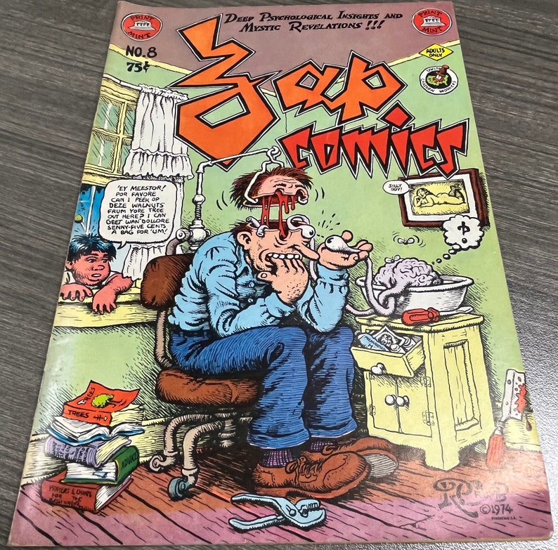May include: A comic book cover with a cartoon illustration of a man with a brain in a sink. The cover is titled "Scab Comics" and features the text "Deep Psychological Insights and Mystic Revelations!!!" The comic book is number 8 and costs 75 cents.