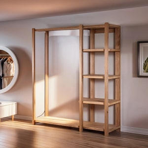 May include: A wooden clothing rack with shelves. The rack has a white background and is made of natural wood. The rack is in a room with a white wall and a round mirror.