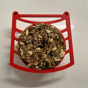 Bird buddy perch with integrated seed cake holder. Holds WBU Wild Birds Unlimited Stackables sized seed and suet cakes. Green