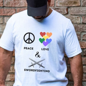 May include: White t-shirt with a peace sign, rainbow hearts, and the text "Peace & Love Swordfighting".