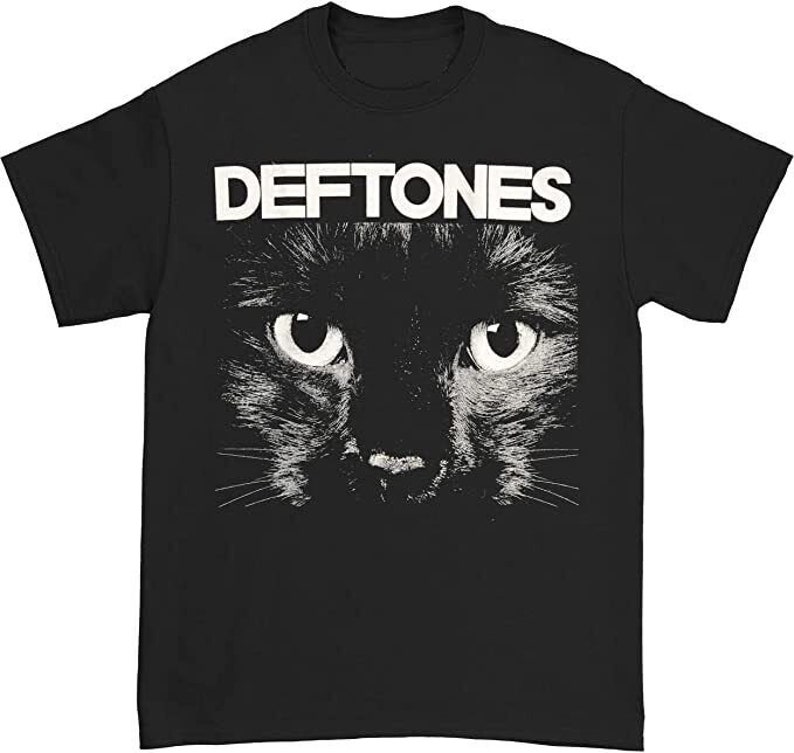 May include: Black t-shirt with a white graphic of a black cat's face with the band name "Deftones" printed in white above the cat.