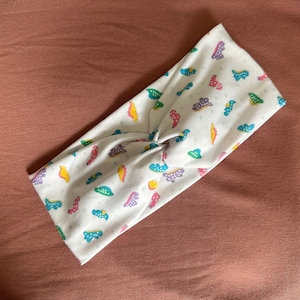 Bandeau torsadé couverture dinosaure
