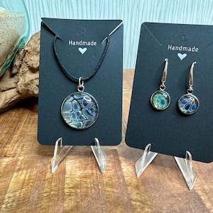 Beautiful jewelry set consisting of a pendant and earrings, shimmering acrylic picture with glass cabochons, including a black necklace