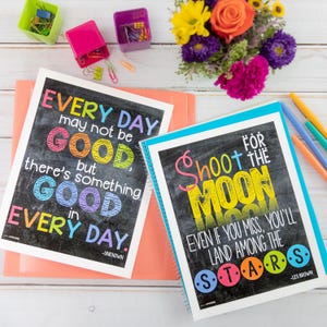 May include: Two inspirational posters with colorful text on a black chalkboard background. The first poster says "Every day may not be good, but there's something good in every day." The second poster says "Shoot for the moon. Even if you miss, you'll land among the stars."