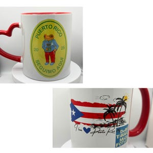 May include: Two white ceramic mugs with red handles. One mug features a green and yellow circular design with a frog wearing a blue shirt and the text "Puerto Rico 20 Seguimo Aqui 25". The other mug features a red, white, and blue Puerto Rican flag with palm trees and the text "I love Puerto Rico Debi Tira Mas Fotos".