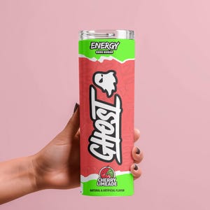 May include: A tall, cylindrical beverage container with a green and red design. The container features the word "ENERGY" and "ZERO SUGAR" in white text. The word "GHOST" is written in large white letters, and the flavor is "CHERRY LIMEADE".