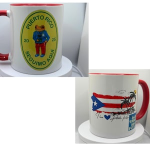 May include: Two white ceramic mugs with red rims. The first mug features a yellow circle with a green border and the text "PUERTO RICO 20 SEGUIMO AQUI 25" and a cartoon frog wearing a blue shirt and red pants. The second mug features a red, white, and blue Puerto Rican flag with palm trees and the text "I love Puerto Rico".