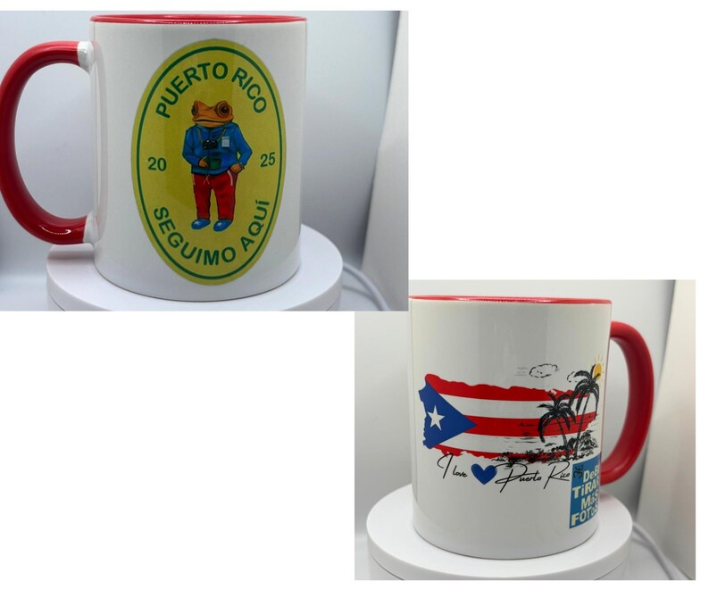 May include: Two white ceramic mugs with red rims. The first mug features a yellow circle with a green border and the text "PUERTO RICO 20 SEGUIMO AQUI 25" and a cartoon frog wearing a blue shirt and red pants. The second mug features a red, white, and blue Puerto Rican flag with palm trees and the text "I love Puerto Rico".
