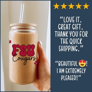 May include: A clear glass tumbler with a bamboo lid and a straw, filled with a light brown liquid. The tumbler features the text "FSU Cougars" in a retro font, with small flower accents. The image includes customer reviews.