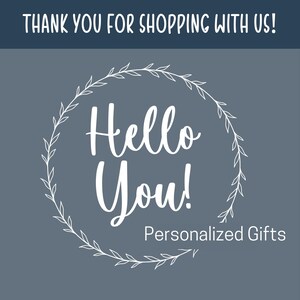 May include: A graphic with the text "THANK YOU FOR SHOPPING WITH US!" at the top. Below, the words "Hello You!" are in a white, cursive font, surrounded by a white floral wreath. The text "Personalized Gifts" is below "Hello You!" on a gray background.