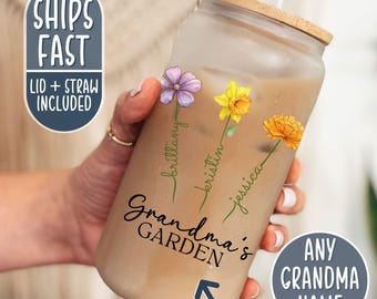 May include: A clear glass tumbler with a bamboo lid and straw. The tumbler has a floral design with the names "Brittany", "Kristin", and "Jessica" written on it. The text "Grandma's Garden" is also on the tumbler.