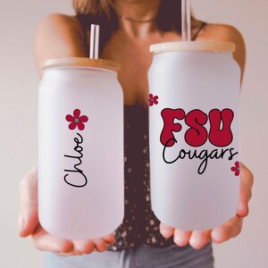 May include: Two frosted glass tumblers with bamboo lids and straws. One tumbler has the name "Chloe" and a red flower graphic. The other has "FSU Cougars" in red lettering with a black outline and a red flower graphic.