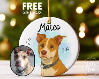 May include: A round ceramic ornament featuring a cartoon dog portrait with the name "Mateo" in black script. The ornament has a gold string for hanging and includes a small photo of the dog. The words "FREE GIFT BOX" are at the top.