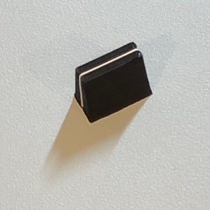 May include: Black rectangular keycap with a white stripe around the edge.